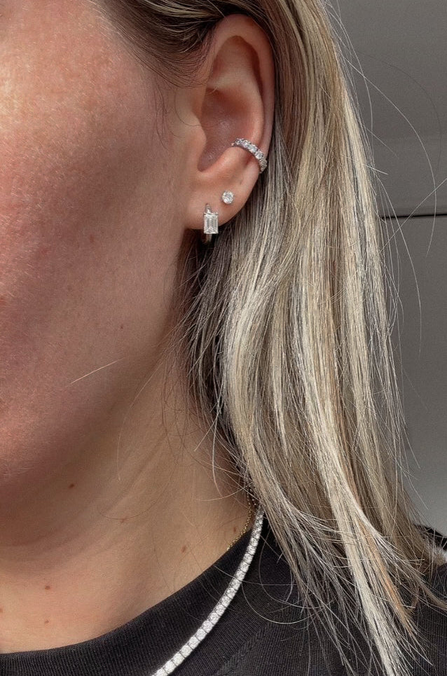 Davey Ear Cuff worn above stacked earrings in a close-up of the ear.