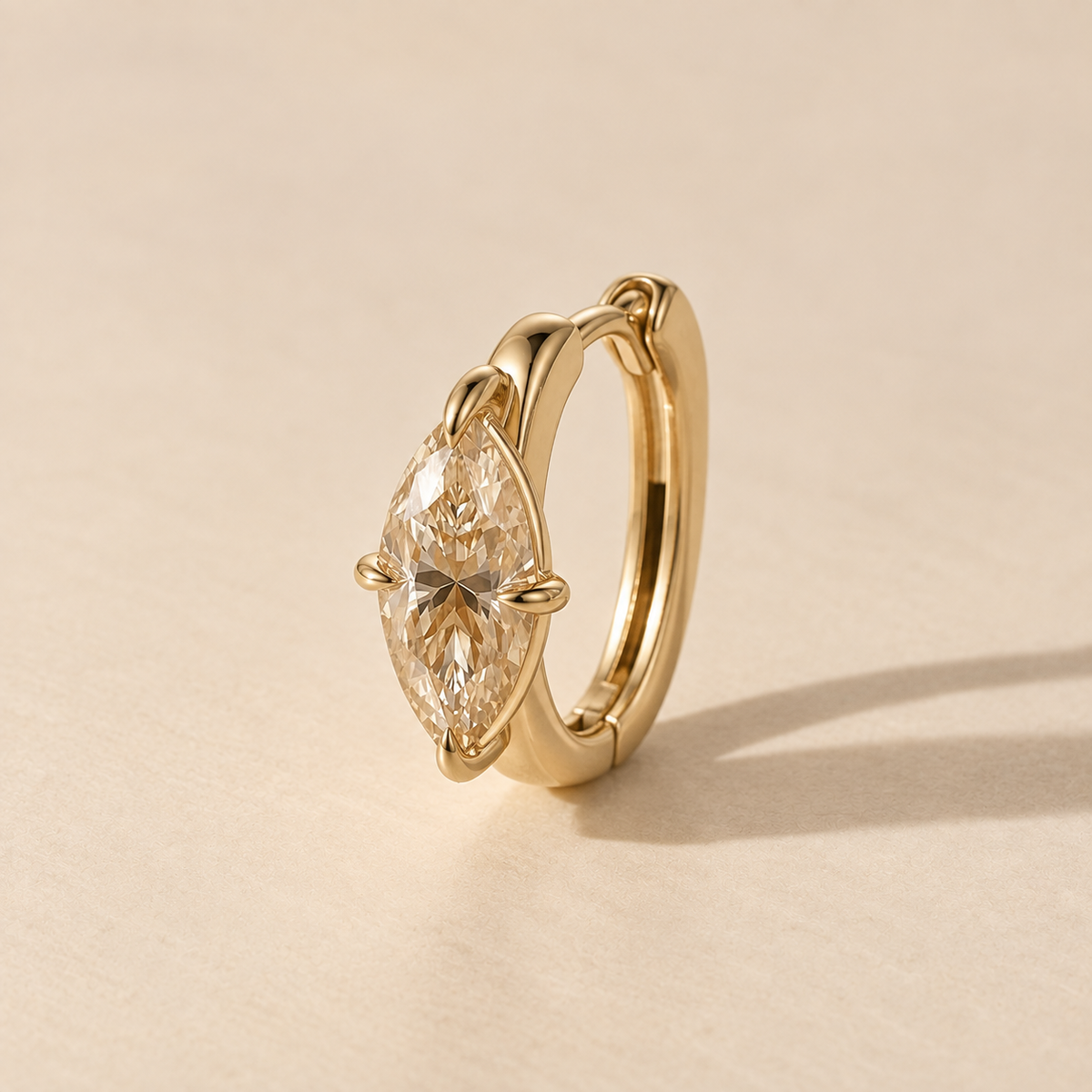 Champagne Marquise Huggie in yellow gold, side view