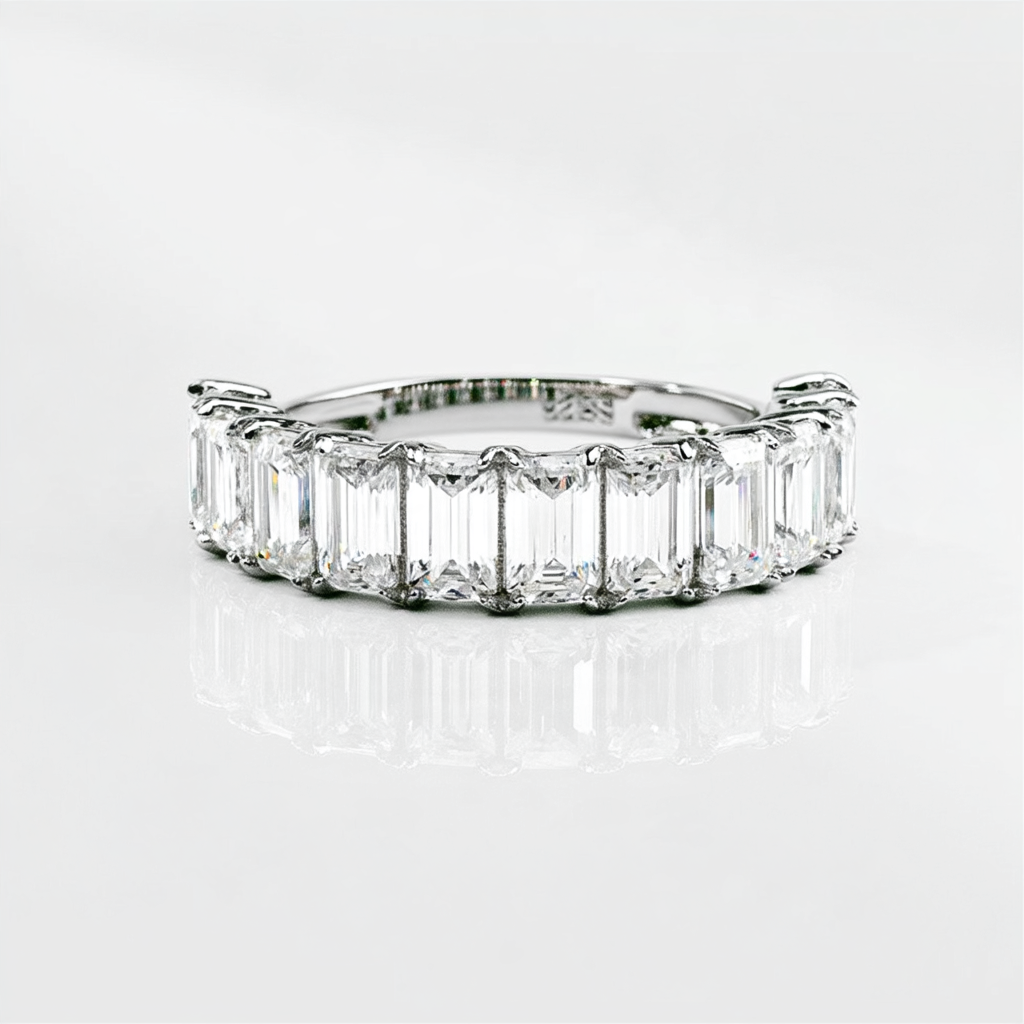 Front view of the Emerald Half Eternity Band with rectangular moissanite stones in rhodium plated sterling silver.